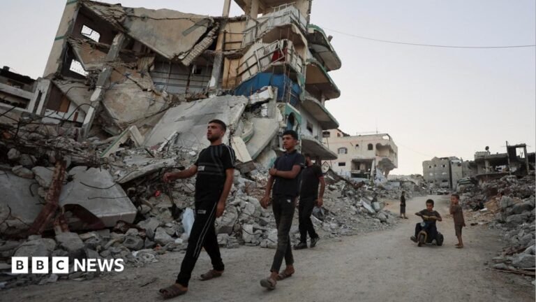 Trump’s Board of Peace unveils $2.45bn Gaza recovery plan Palestinians walk past the rubble of destroyed buildings in Gaza City, northern Gaza (22 September 2026)