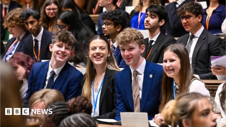 UK Youth Parliament looks set to be axed Earl Spencer walking, wearing a navy suit and a purple tie.