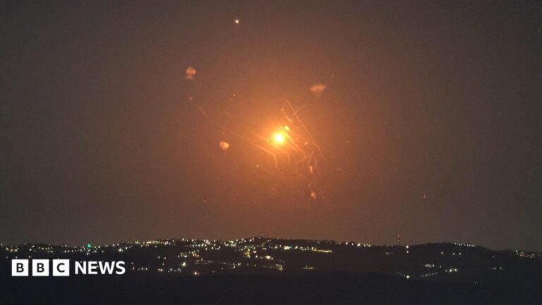 A red and orange missile being intercepted by Jordanian air defences in the sky as seen from the Israeli side of the Jordan Valley.
