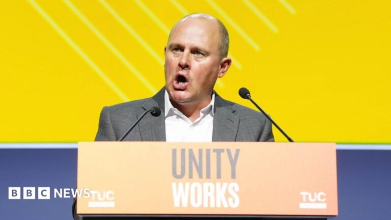 Unions warn against ‘out of control’ political spending Jack Clark, a man with short brown hair, dressed in a blue coat