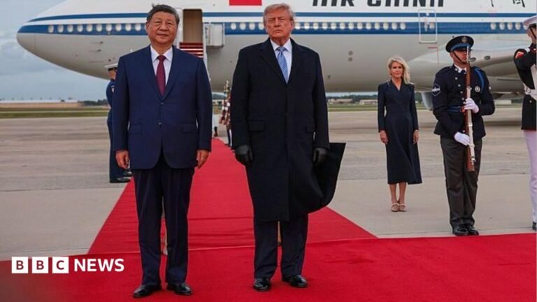 US President Donald Trump holds a binder as he stands next to Chinese President Xi Jinping before Xi delivers a speech during a state dinner at the White House in Washington
