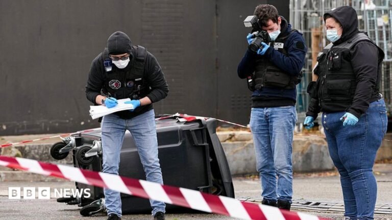 Anti-terror police investigate as one person killed in shooting near Paris Large waves crashing over a black and white striped lighthouse at the end of a pier.