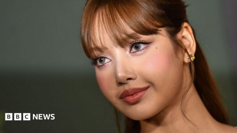 Blackpink’s Lisa Manobal: How the K-pop star faced a race scandal Lisa Manobal is pictured on a red carpet, looking off camera. A camera flash illuminates her eyes