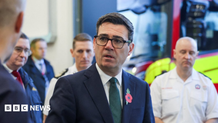 Burnham suggests stocking up on tinned food and bottled water Large waves crashing over a black and white striped lighthouse at the end of a pier.