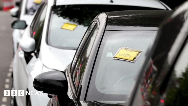 Burnham vows end to ‘rip-off parking charges’ under new rules A generic-looking image shows a row of cars seen front-on with yellow and black Penalty Charge Notices affixed to their windscreens, on a road near Gatwick Airport in 2017.