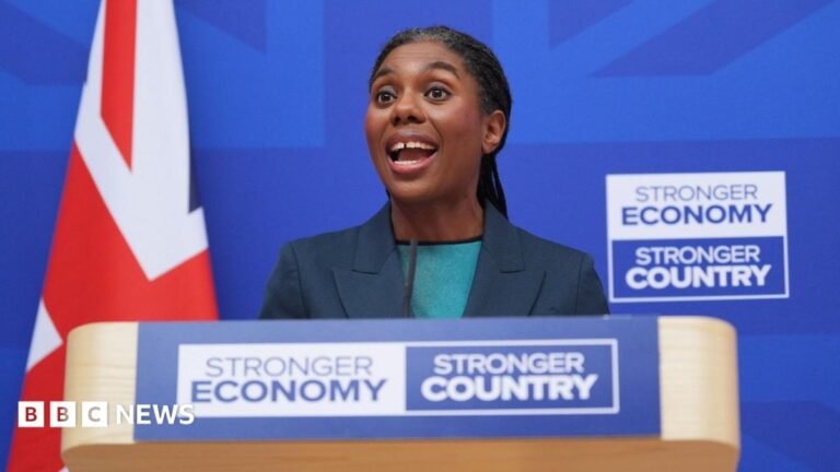 Conservatives aim to be election-ready ahead of party conference Kemi Badenoch makes a speech at a lectern bearing the slogan 'Stronger Economy, Stronger Country'. She is wearing a dark jacket and green top, and behind her is a union jack flag.