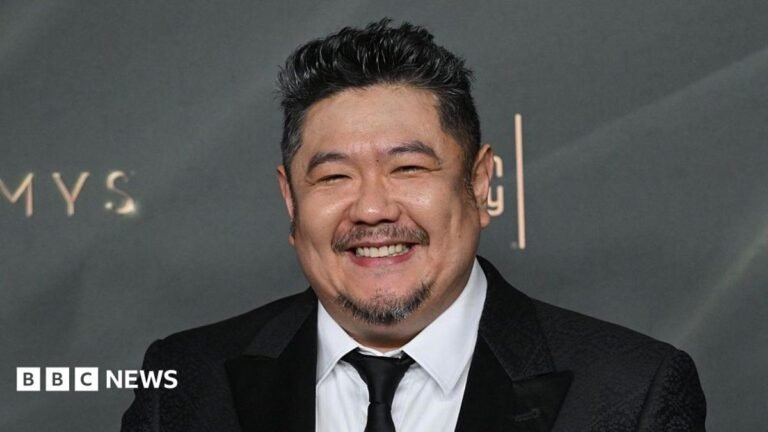 Eric Bauza, voice of Bugs Bunny and Daffy Duck, dies aged 46 A man in a dark suit with a close-cropped goatee smiles at a premiere