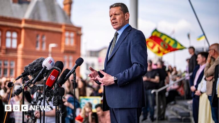 First minister demands ‘new deal’ for Wales before Plaid Cymru conference The image shows Rhun ap Iorwerth addressing a crowd outside the Senedd following May's Senedd election result.
