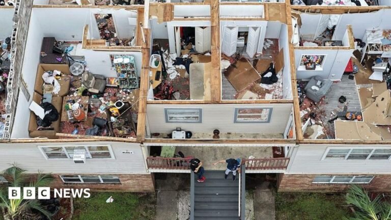 Four dead and thousands without power after Hurricane Isaias lashes US An apartment complex is seen from above, after the roof was blown off in Milton, Florida