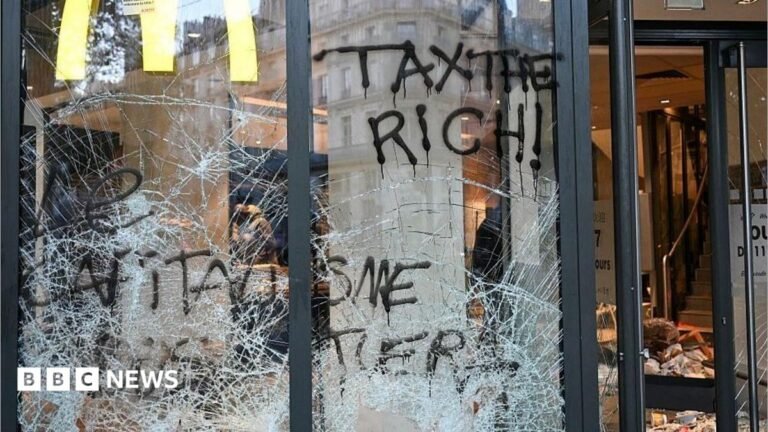 France protests: Burnt out cars and shattered glass on Paris streets after protests turn to riots and looting This photograph shows the entrance of a McDonald's covered in graffiti and damaged a day after nationwide protests against the "high cost of living", in Paris on October 18, 2026.