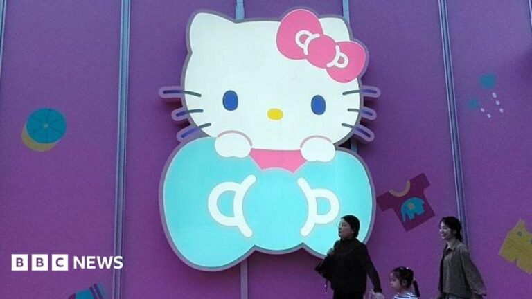 Hello Kitty maker cuts ties with Japanese spy drama after China backlash Three women walk past a big glowing Hello Kitty signage on a purple store wall in Shanghai, China
