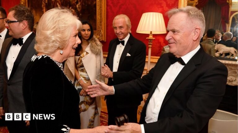 Jeffrey Archer: Queen Camilla pays tribute to ‘irrepressible’ author and former politician Queen Camilla and Jeffrey Archer at a charity reception in 2018. They are greeting each other warmly and both are dressed formally.