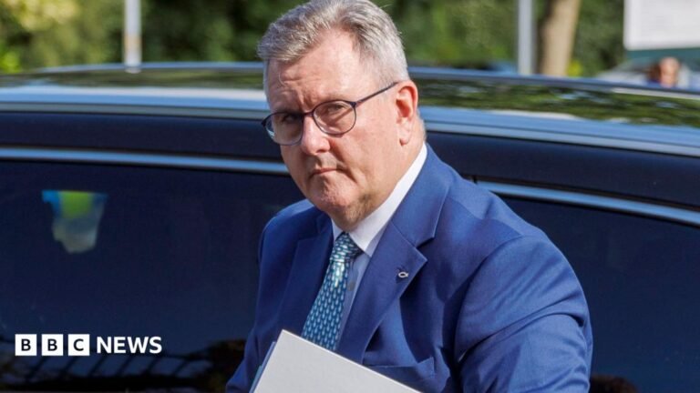 Jeffrey Donaldson to be interviewed over alleged rape inside Houses of Parliament Donaldson has short grey hair and is wearing a blue suit, white shirt and patterned tie. He has round black metal glasses, and is walking in front of a car holding a folder while arriving at Newry Crown Court in Northern Ireland on 8 June.