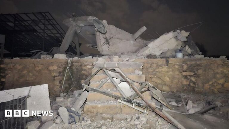 Rubble sits atop a small brick wall and six stairs.