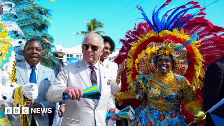 King Charles shows off dance moves on second day of Caribbean tour King Charles, wearing a light beige suit with military medals displayed speaks to veterans wearing white uniforms highlighted with green