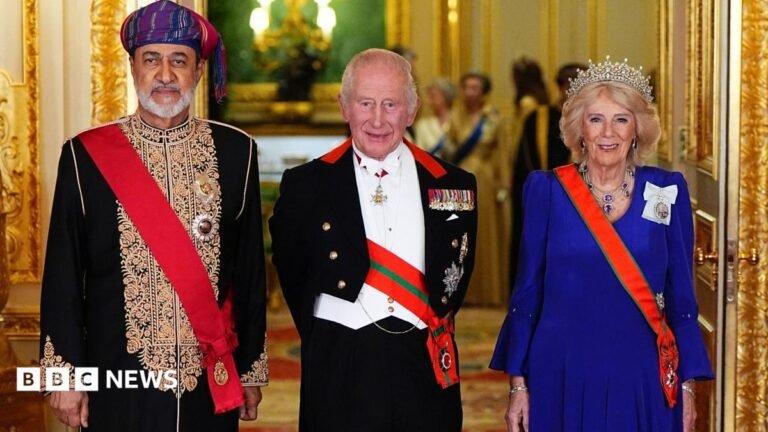 King praises Strait of Hormuz peace efforts at glittering banquet Somebody holding up a smart-phone in their right hand. The screen is black with 'Revolut' written in white letters.