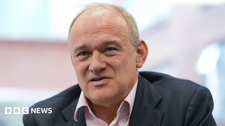 Lib Dems criticise Ed Davey over pension triple lock response Ed Davey wearing a dark grey suit and a pink shirt