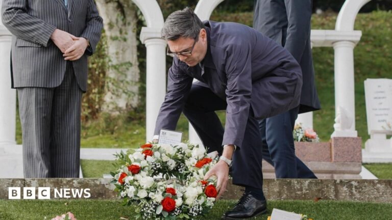 Prime Minister Andy Burnham visits Aberfan ahead of 60th anniversary Three men in suits are seeing bowing and holding their hands in front of them