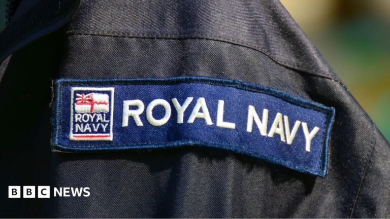 Royal Navy service member charged with spying Man with blonde bob pointing at camera