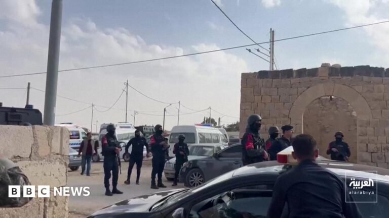 Seven shot dead by gunmen at church funeral in Jordan, officials say Large waves crashing over a black and white striped lighthouse at the end of a pier.