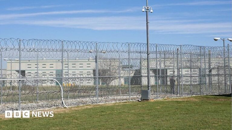 A fence, barbed wire and a guard are visible at the Allan B. Polunsky Unit, the prison that houses the men on Texas' death row in Livingston, Texas