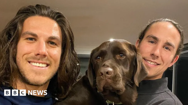 Three men found guilty of murdering two Australian surfer brothers and US friend A young man with shoulder-length brown hair and light stubble smiling at the camera, and another young man to his right and a brown dog in between them