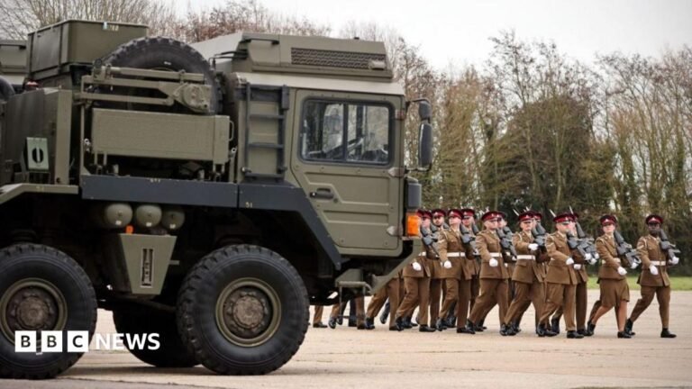 Tories pledge new ‘Britannia Shield’ UK air defence system Troops march eyes right next to an Army vehicle.