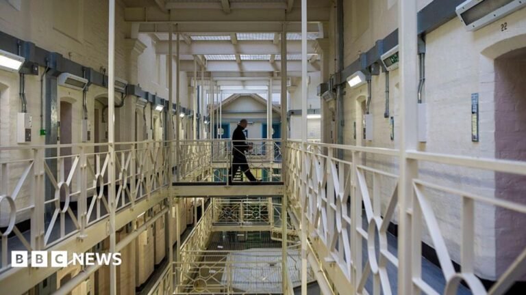 Tories pledge to build 50,000 new prison places A prisoner officer walks along a balcony in HMP Portland, Dorset.