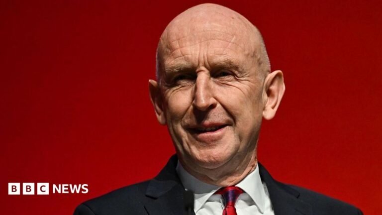UK economy sees surprise growth in August ahead of Healey’s first Budget MI5 chief Sir Ken McCallum has short dark hair, dark glasses and is wearing a dark suit with a green tie.