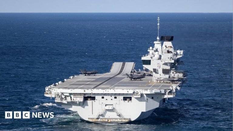UK’s gaps in Arctic defence leave it open to Russian attacks, committee says Somebody holding up a smart-phone in their right hand. The screen is black with 'Revolut' written in white letters.