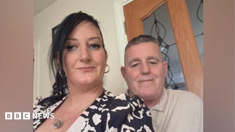 Waterford: Murder investigation after four die in arson attack Kim English - a woman with long, black hair swept back from her face - looks to the camera in a selfie-style photo. Her husband Philip English is standing close to her smiling. He has short grey hair and is wearing a beige polo shirt and a silver necklace with a cross-shaped pendant. She is wearing a black and white patterned jacket and a silver necklace.