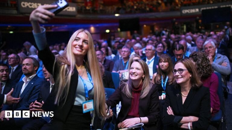 Why Tories are talking about winning the next election A young woman with long blonde hair takes a selfie with shadow housing secretary Katie Lam, who is sitting in the conference hall with Tory members